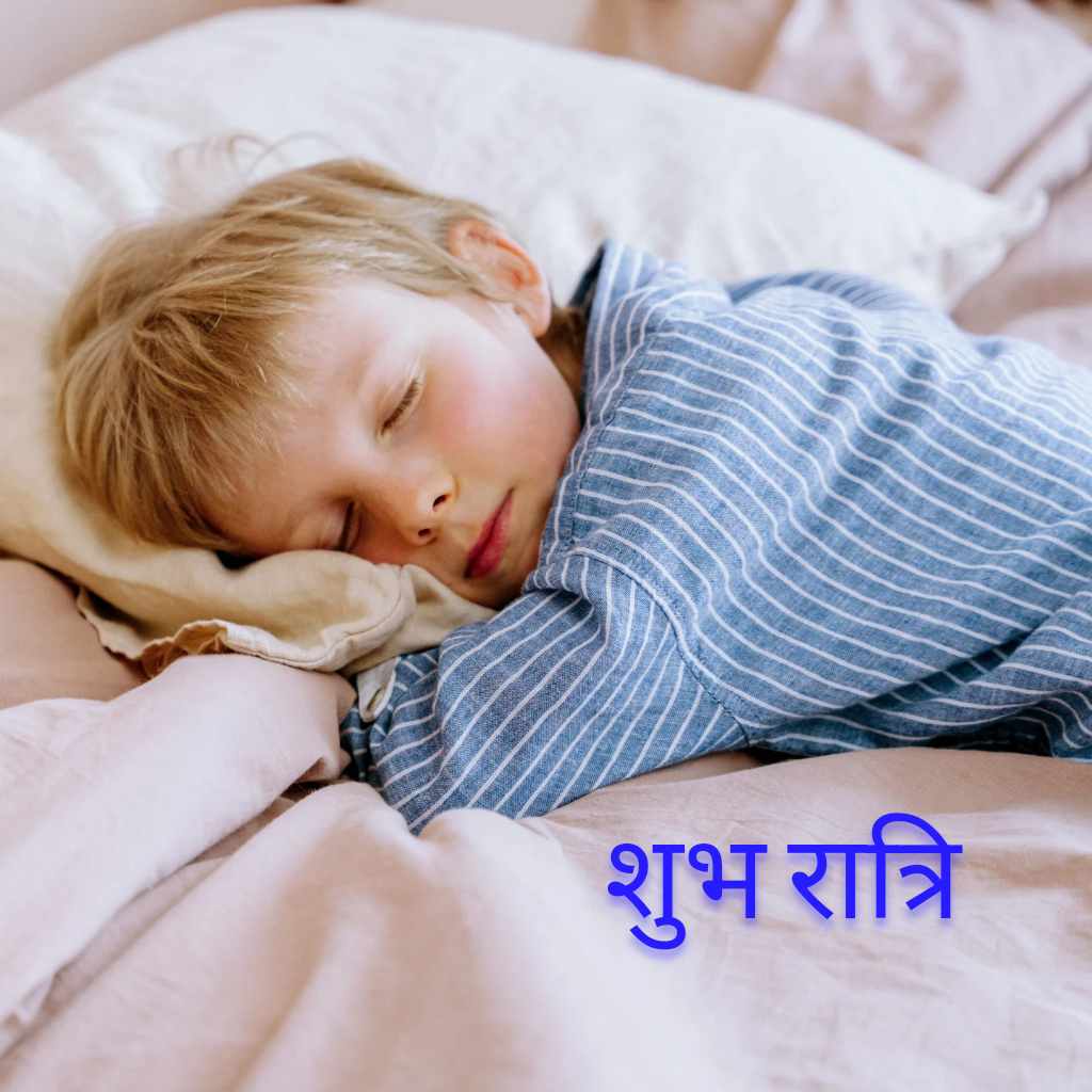 A child is sleeping on the bed with Good Night Hindi Image.